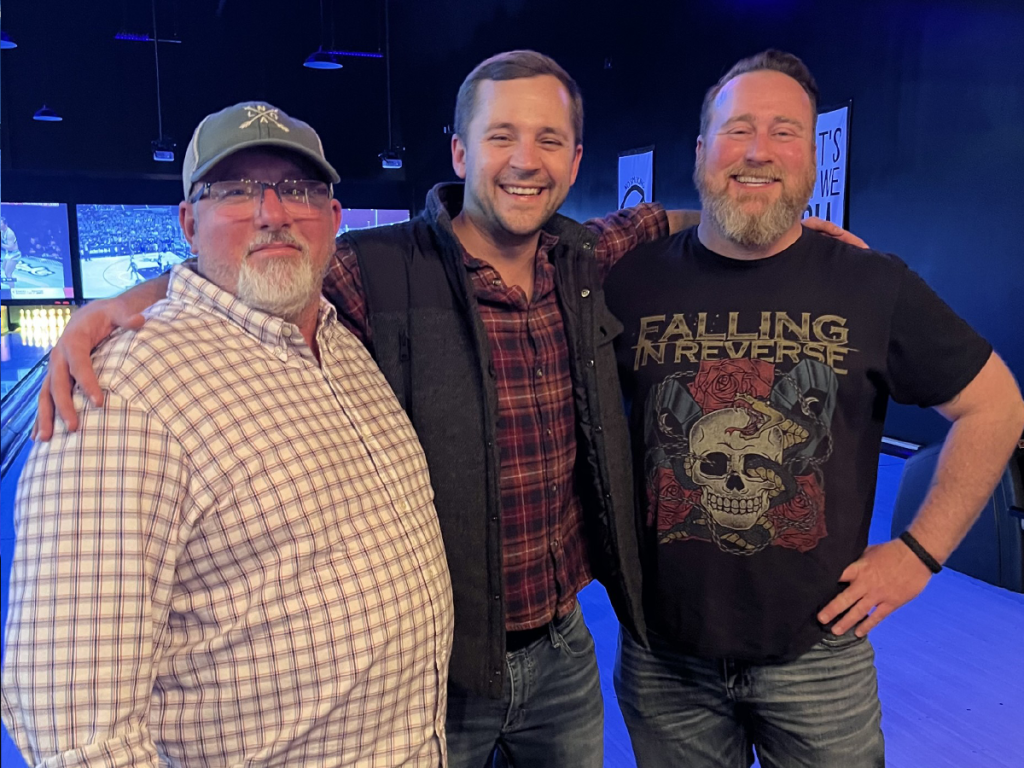 Three team members from Wyatt Johnson Mazda at a team building community event