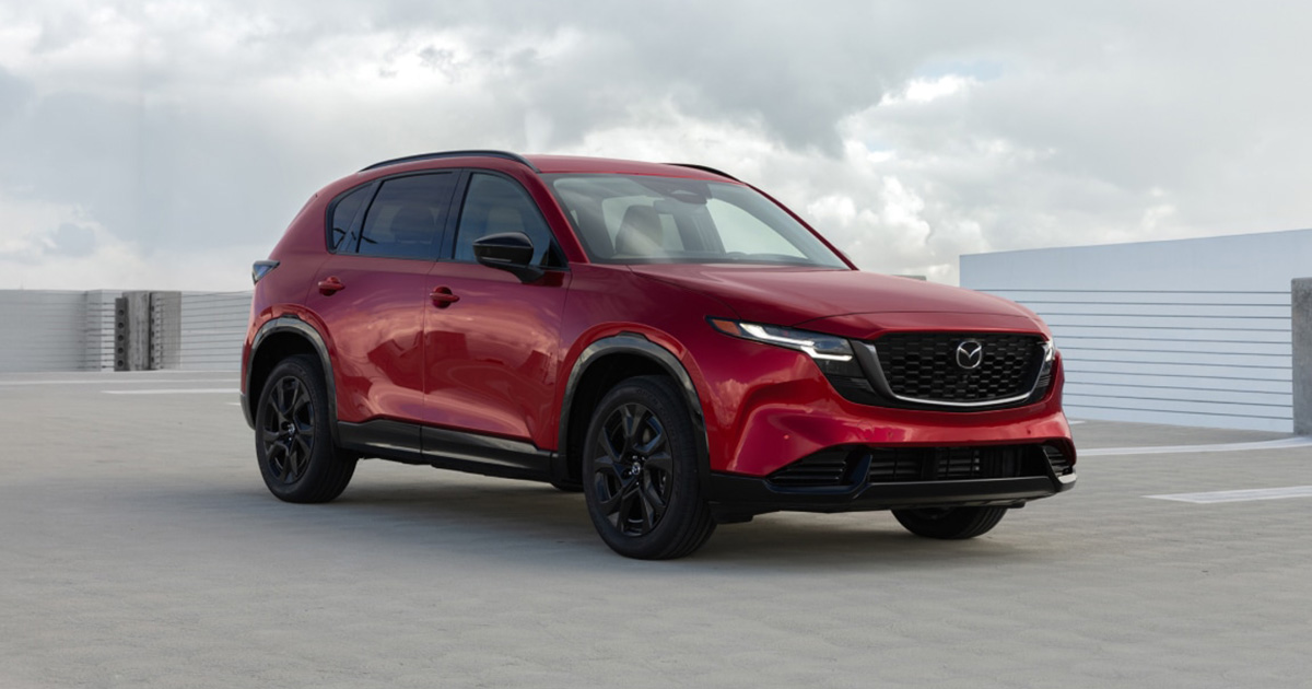A red Mazda CX-5 parked at the top of a parking garage.