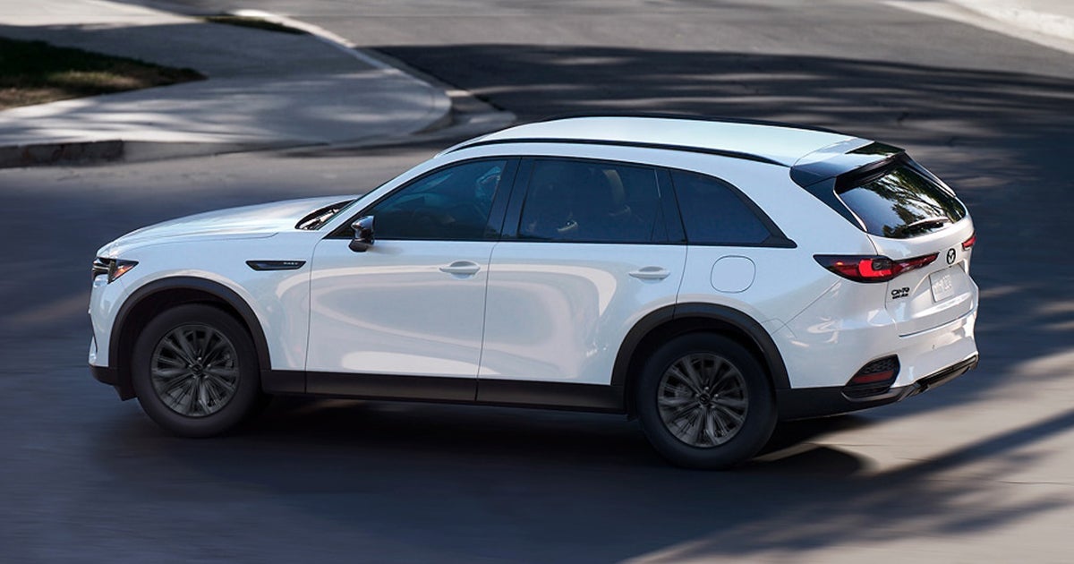 A white Mazda CX-90 on the road.